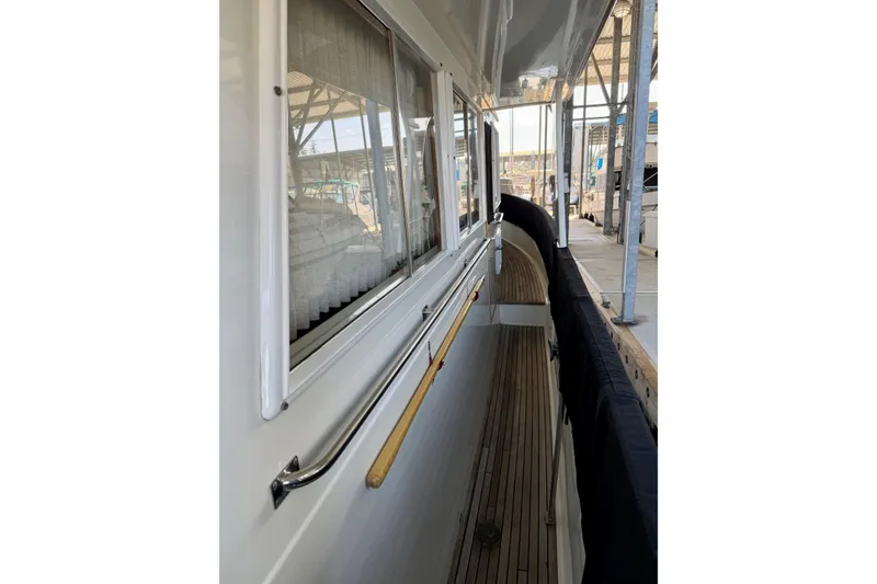 Slide: The Image of Side view of 1991 Grand Banks 36 Europa yacht docked in a marina. - 13