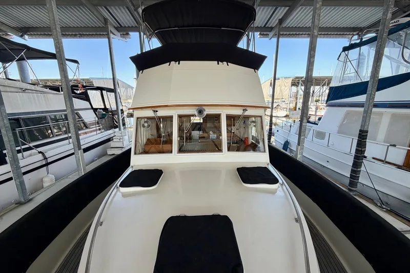 Slide: The Image of 1991 Grand Banks 36 Europa yacht docked in a marina, showcasing its classic design. - 16