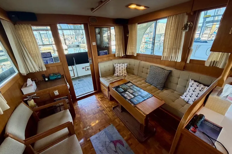 Slide: The Image of Interior of 1991 Grand Banks 36 Europa yacht with cozy seating and nautical decor. - 18