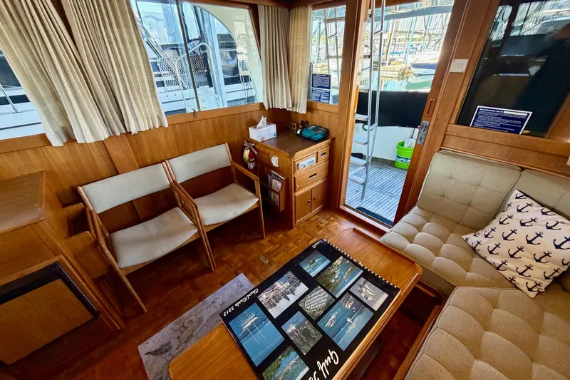 Slide: The Image of Interior of 1991 Grand Banks 36 Europa yacht with cozy seating and nautical decor. - 19