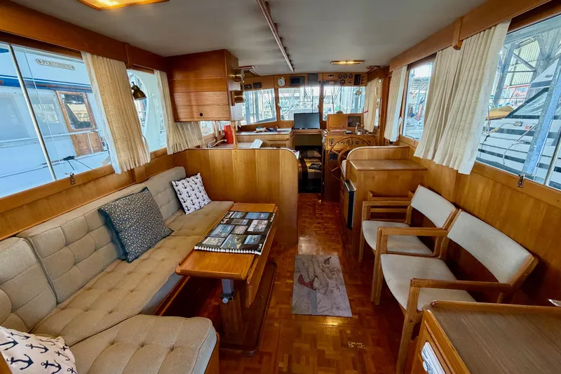 Slide: The Image of Interior of 1991 Grand Banks 36 Europa yacht, featuring cozy seating and wooden decor. - 20