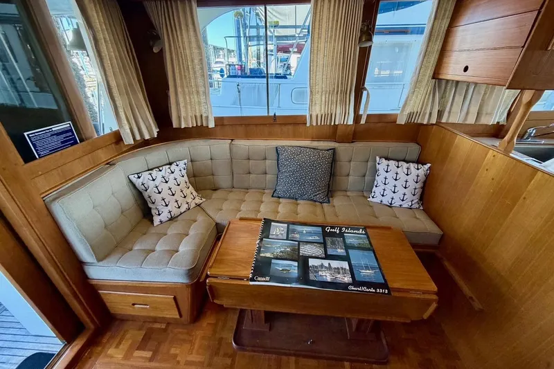 Slide: The Image of Cozy interior of 1991 Grand Banks 36 Europa with cushioned seating and nautical decor. - 21
