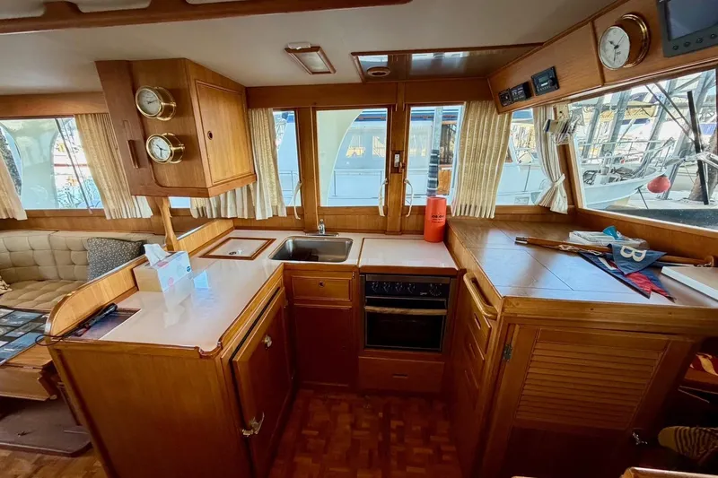 Slide: The Image of Interior of 1991 Grand Banks 36 Europa yacht with wooden cabinetry and kitchen amenities. - 22