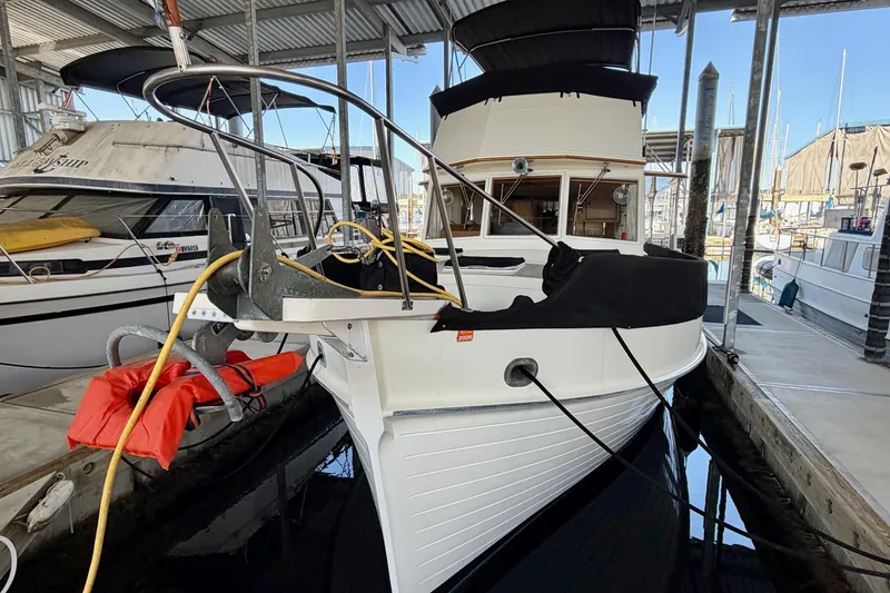 Slide: The Image of 1991 Grand Banks 36 Europa yacht docked in a marina under a covered shelter. - 3