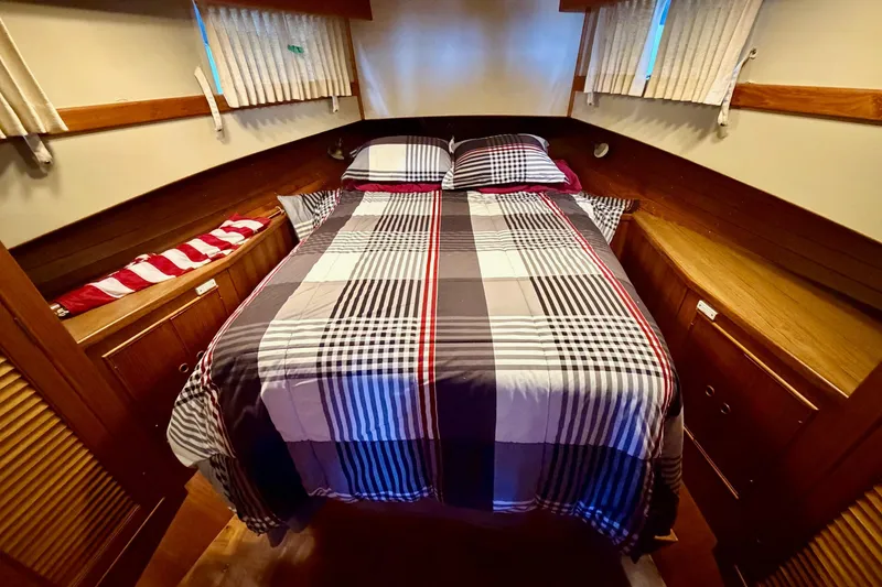 Slide: The Image of Cozy cabin interior of 1991 Grand Banks 36 Europa with plaid bedding. - 32