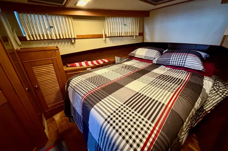 Slide: The Image of Cozy bedroom interior of 1991 Grand Banks 36 Europa yacht with plaid bedding. - 33
