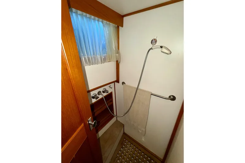 Slide: The Image of Shower area in 1991 Grand Banks 36 Europa yacht with wooden accents and towel rail. - 35
