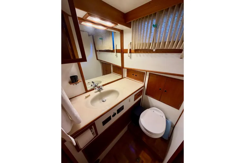 Slide: The Image of Bathroom interior of 1991 Grand Banks 36 Europa yacht, featuring sink and toilet. - 36