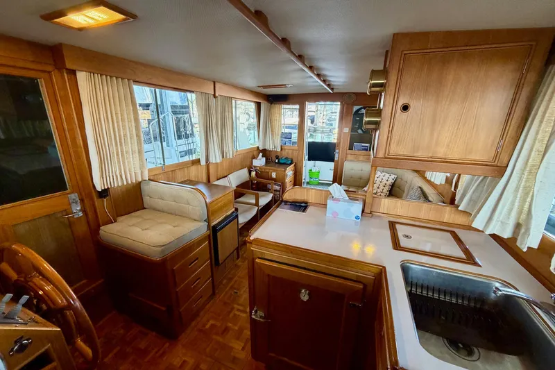 Slide: The Image of Interior of 1991 Grand Banks 36 Europa yacht with wood finish and seating area. - 38
