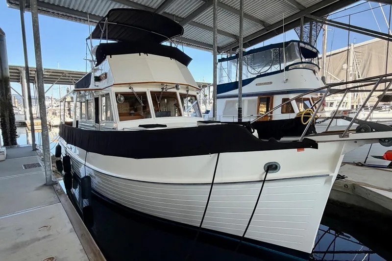 Slide: The Image of 1991 Grand Banks 36 Europa yacht docked in a marina under a covered shelter. - 4