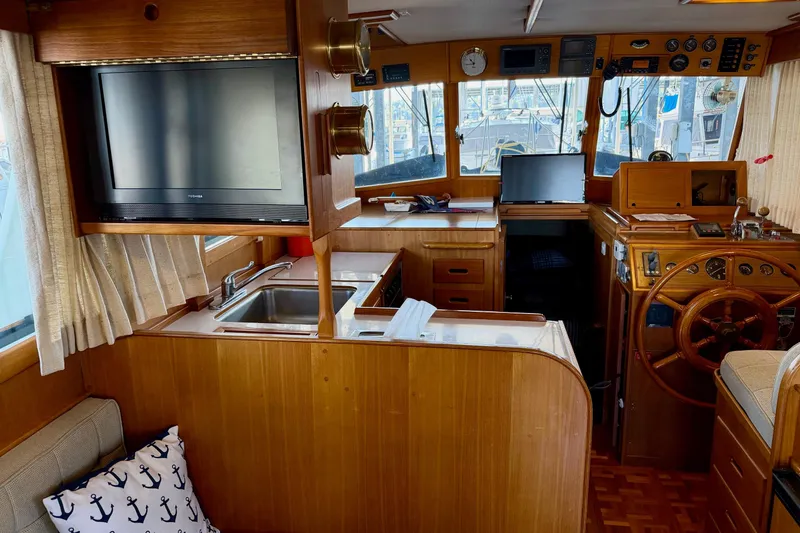 Slide: The Image of Interior of 1991 Grand Banks 36 Europa yacht with helm, kitchen, and TV. - 40