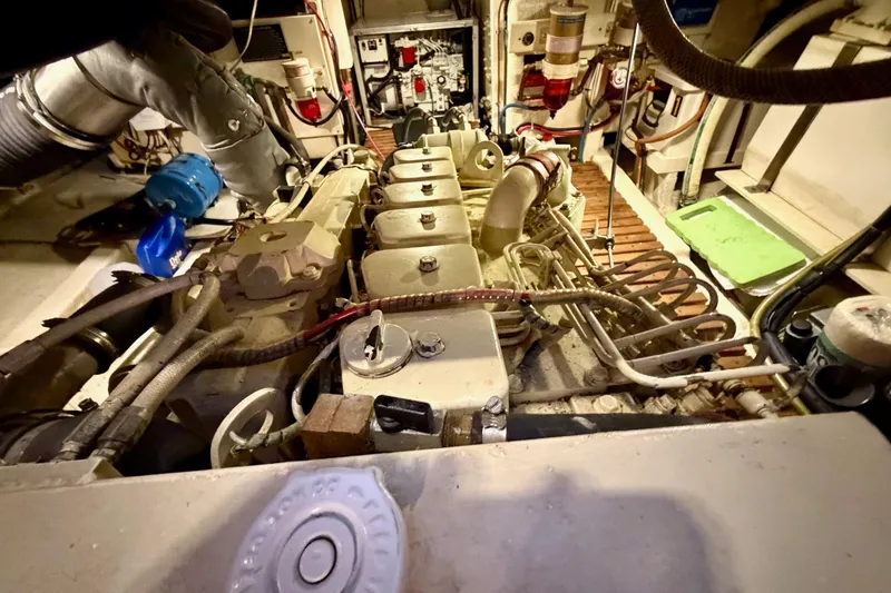 Slide: The Image of Engine room of a 1991 Grand Banks 36 Europa yacht, showcasing mechanical components. - 41