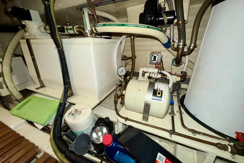 Slide: The Image of Engine room of 1991 Grand Banks 36 Europa with mechanical components and storage items. - 46