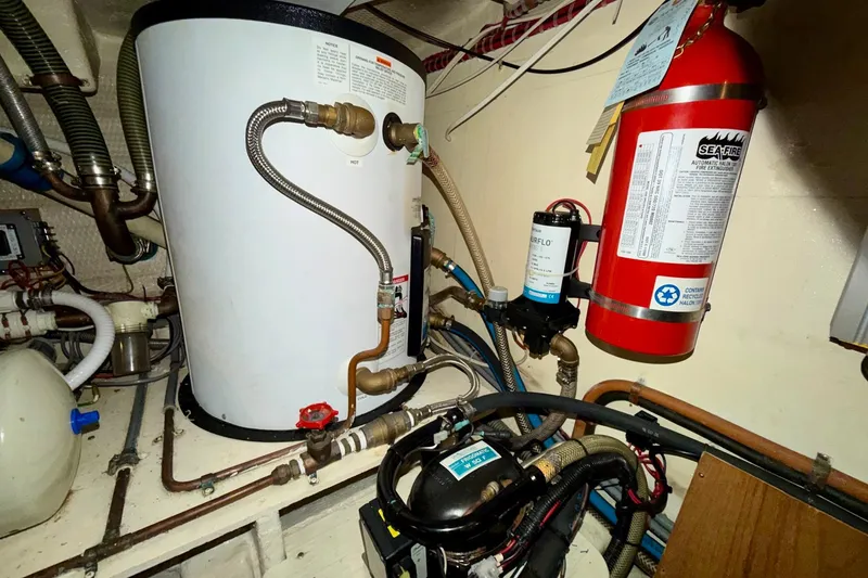 Slide: The Image of Engine room of 1991 Grand Banks 36 Europa with fire extinguisher and water heater. - 47