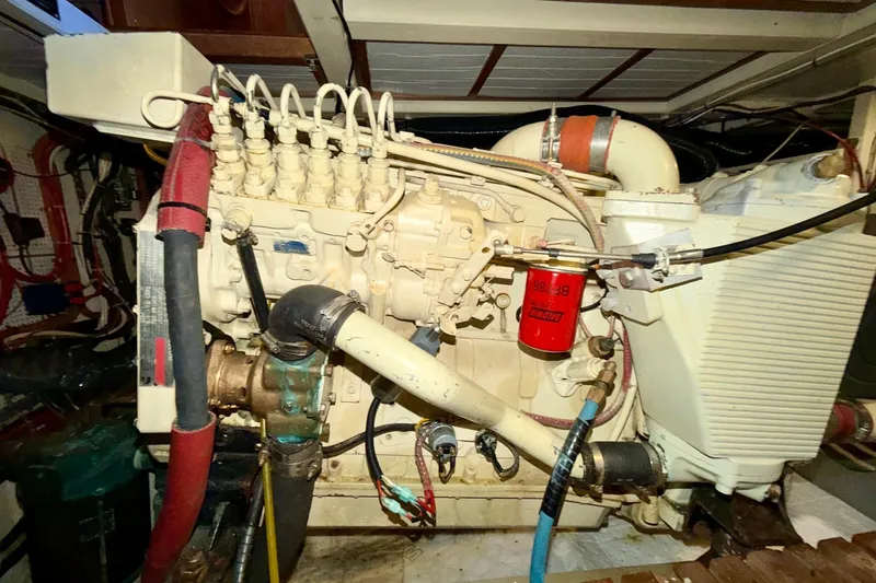 Slide: The Image of Engine room of a 1991 Grand Banks 36 Europa yacht, showcasing detailed machinery. - 48