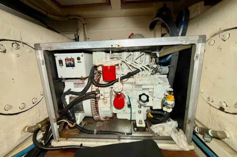 Slide: The Image of Engine compartment of a 1991 Grand Banks 36 Europa boat, showcasing mechanical components. - 49