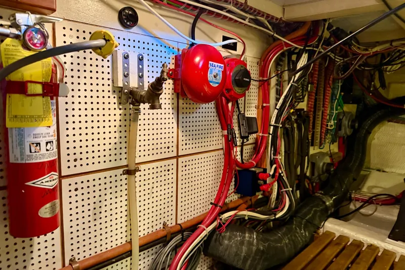 Slide: The Image of Engine room of 1991 Grand Banks 36 Europa with fire extinguisher and wiring. - 55
