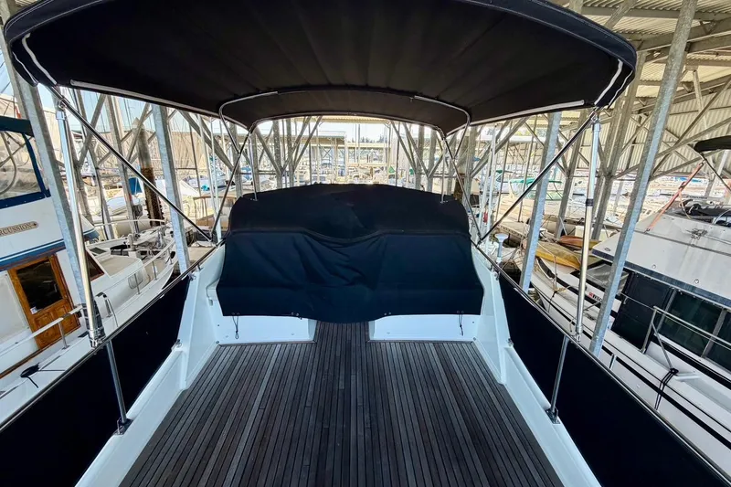 Slide: The Image of 1991 Grand Banks 36 Europa yacht with covered deck, docked in a marina. - 56