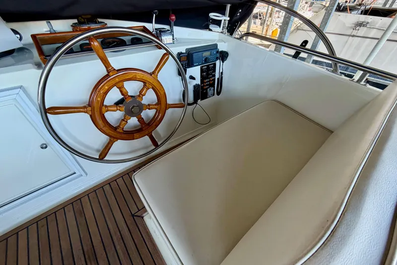 Slide: The Image of Helm of 1991 Grand Banks 36 Europa with wooden wheel and navigation controls. - 59