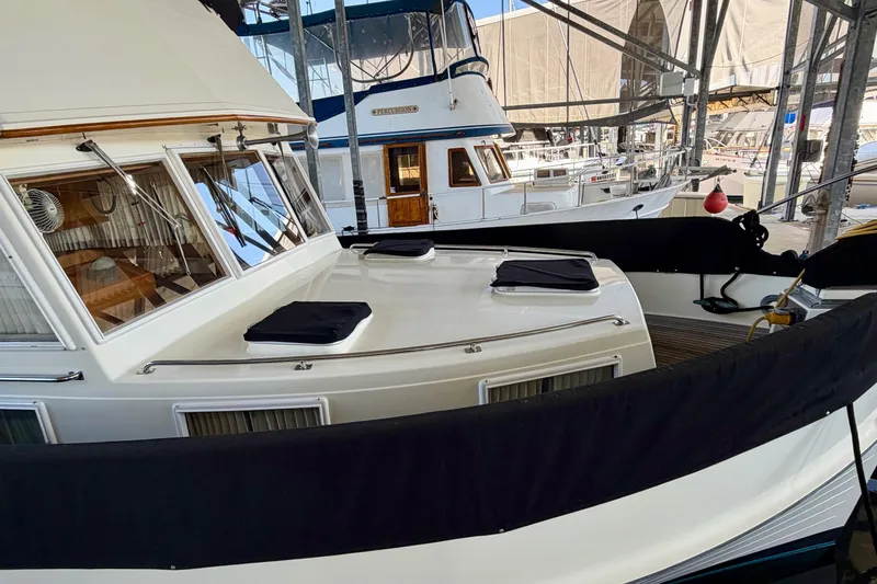 Slide: The Image of 1991 Grand Banks 36 Europa yacht docked in a marina, showcasing classic design. - 6