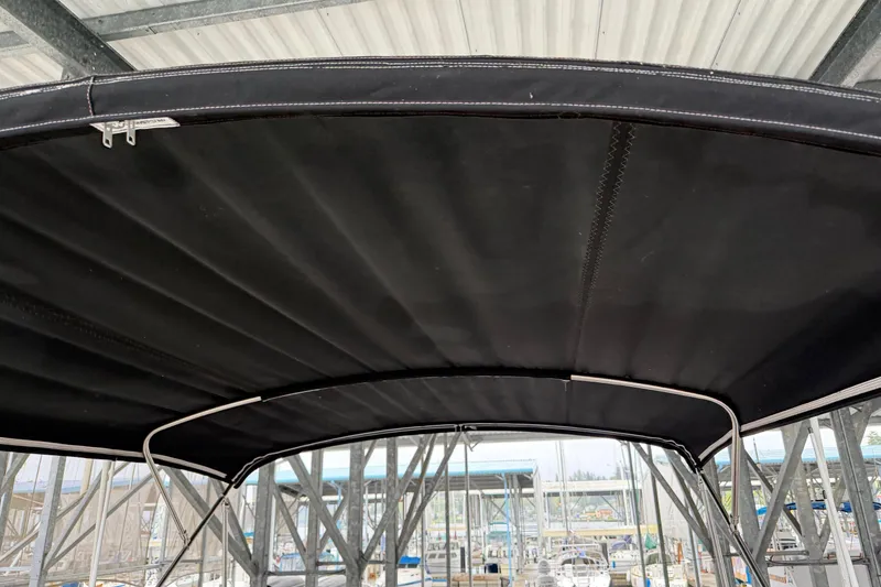 Slide: The Image of Black canopy of a 1991 Grand Banks 36 Europa boat under a metal roof. - 61