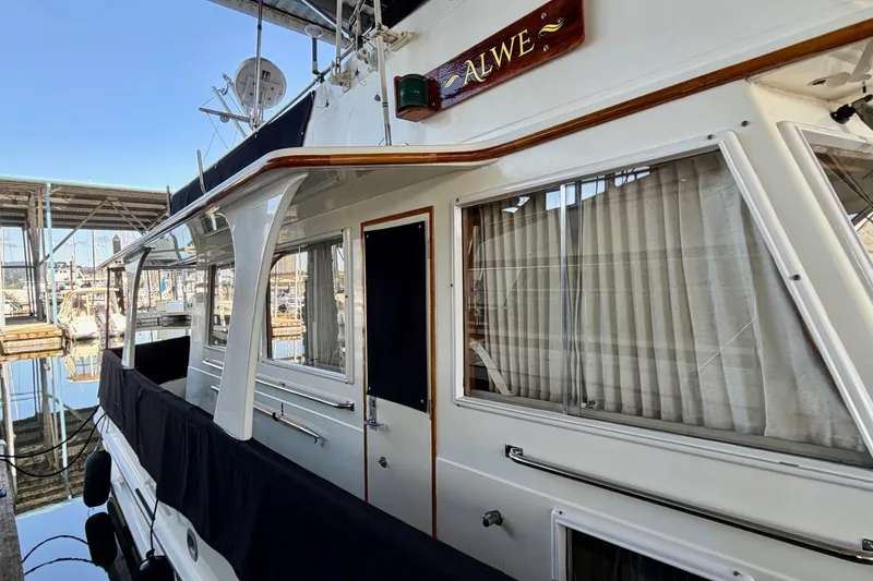 Slide: The Image of 1991 Grand Banks 36 Europa yacht docked, featuring elegant design and classic wood accents. - 7