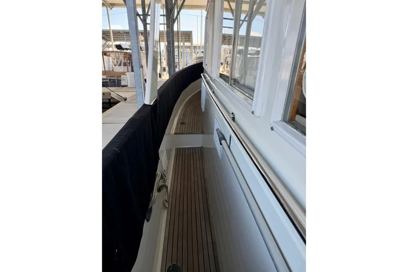 Slide: The Image of Side deck view of 1991 Grand Banks 36 Europa yacht in marina. - 9