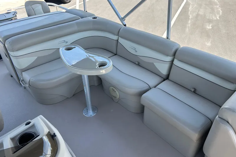 Slide: The Image of 2015 Bennington 22 SSX boat interior with gray seating and a central table. - 10