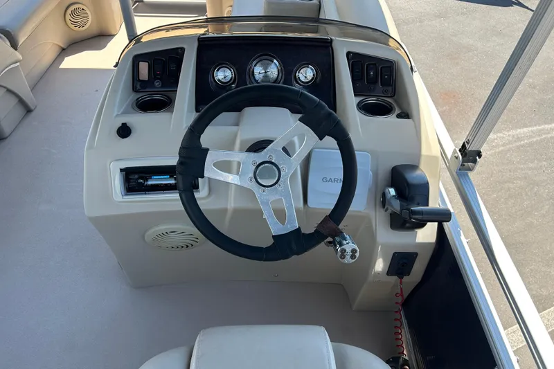 Slide: The Image of Steering console of a 2015 Bennington 22 SSX boat with gauges and controls. - 12