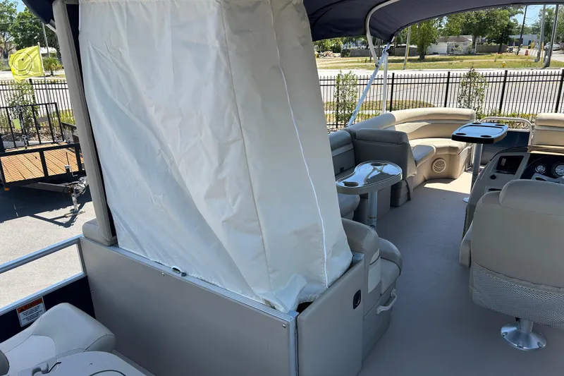 Slide: The Image of 2015 Bennington 22 SSX pontoon boat interior with seating and canopy. - 16