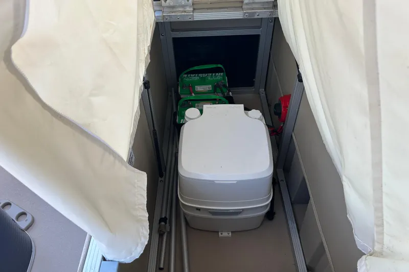 Slide: The Image of Portable toilet and battery storage on 2015 Bennington 22 SSX boat. - 17