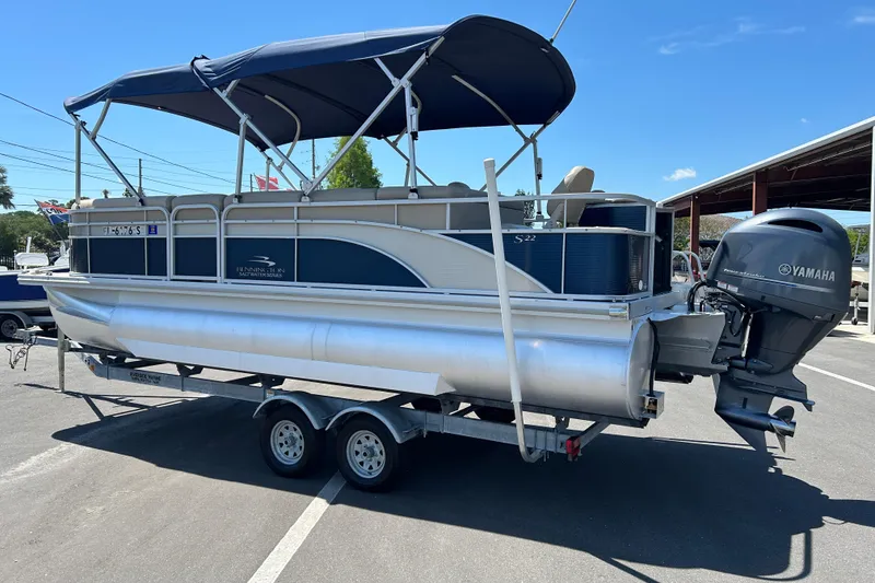 Slide: The Image of 2015 Bennington 22 SSX pontoon boat with Yamaha outboard motor on trailer. - 4