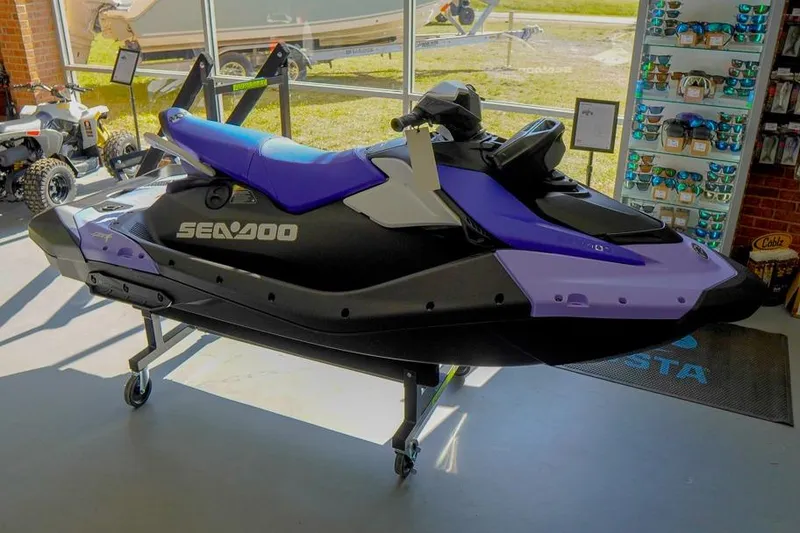 The Image of 2026 Sea-Doo Spark for 3 jet ski in showroom, purple and black design. - 1