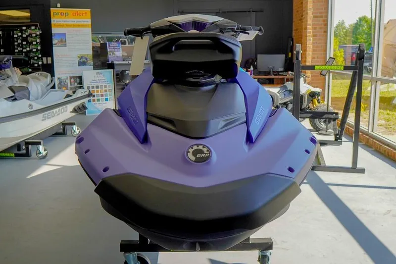 Slide: The Image of 2026 Sea-Doo Spark for 3 jet ski displayed in showroom, featuring sleek design and vibrant color. - 3