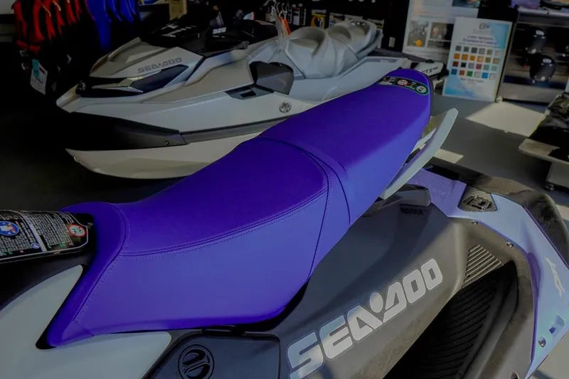 Slide: The Image of 2026 Sea-Doo Spark for 3 with purple seat in showroom display. - 6