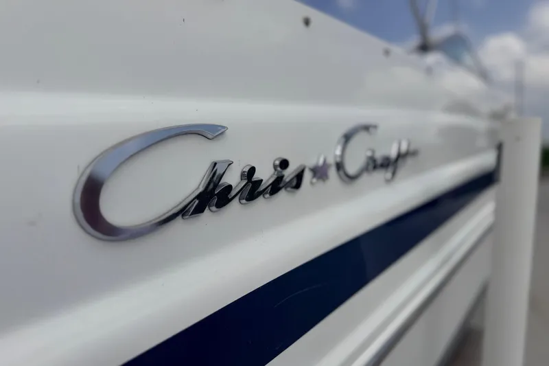 Slide: The Image of Close-up of 2000 Chris Craft 262 Sport Deck logo on boat exterior. - 10