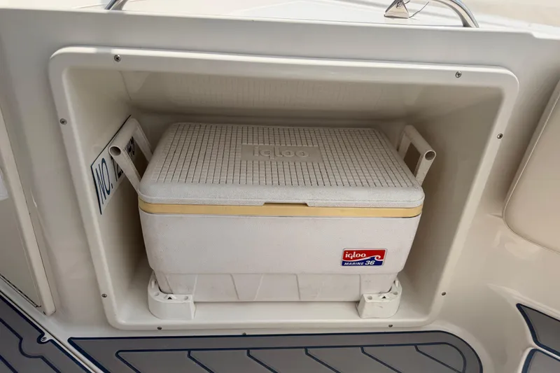 Slide: The Image of Igloo cooler stored on a 2000 Chris Craft 262 Sport Deck boat. - 14