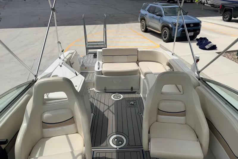 Slide: The Image of 2000 Chris Craft 262 Sport Deck boat interior with beige seating and modern design. - 16