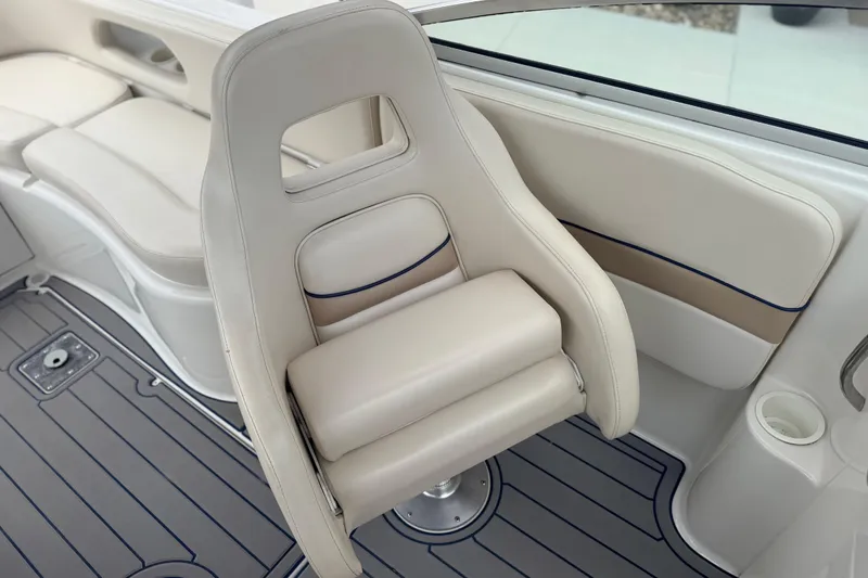 Slide: The Image of 2000 Chris Craft 262 Sport Deck boat interior with white seating and sleek design. - 17