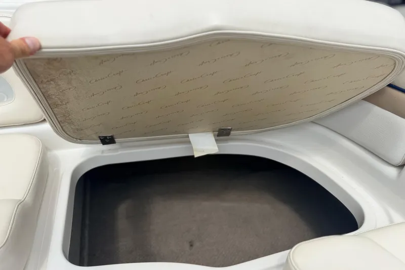 Slide: The Image of Open storage compartment on a 2000 Chris Craft 262 Sport Deck boat. - 19