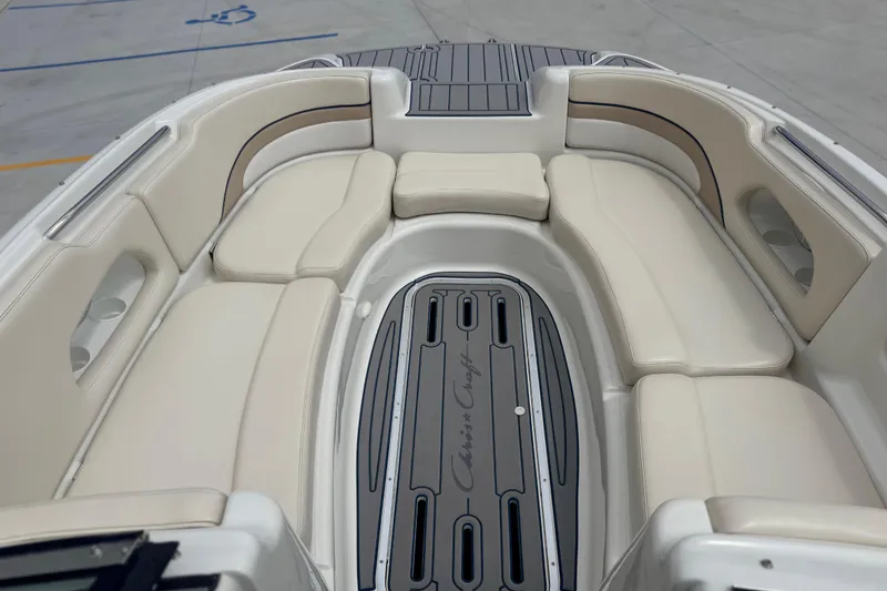Slide: The Image of 2000 Chris Craft 262 Sport Deck boat interior with beige seating and branded flooring. - 21