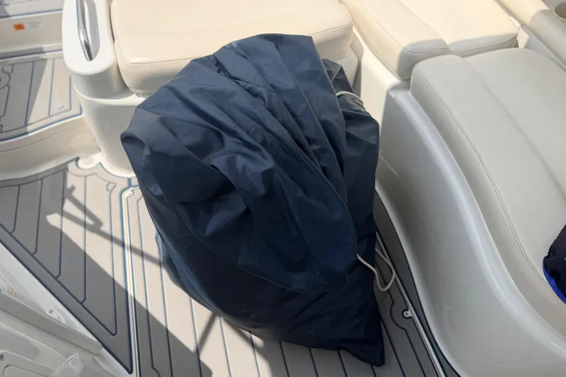 Slide: The Image of 2000 Chris Craft 262 Sport Deck interior with navy cover on deck. - 22