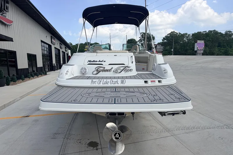 Slide: The Image of 2000 Chris Craft 262 Sport Deck boat at dock, rear view with canopy. - 3