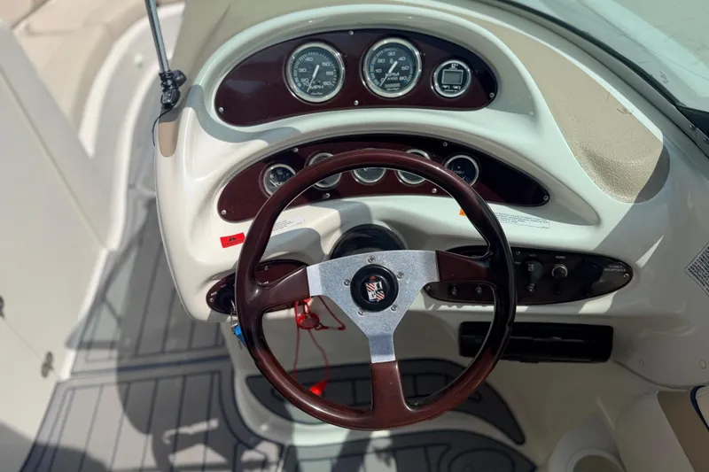 Slide: The Image of Steering wheel and dashboard of a 2000 Chris Craft 262 Sport Deck boat. - 32