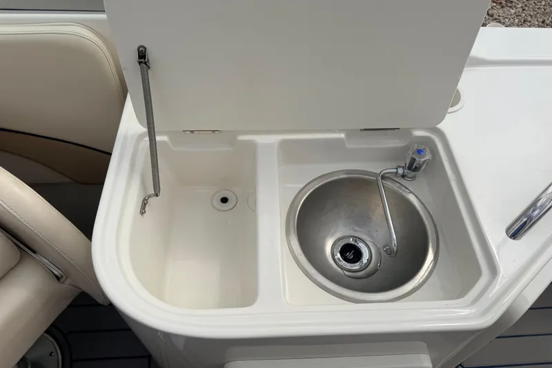 Slide: The Image of 2000 Chris Craft 262 Sport Deck boat sink and storage compartment. - 40