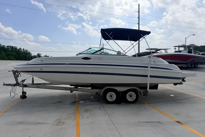 Slide: The Image of 2000 Chris Craft 262 Sport Deck boat on trailer in parking lot. - 5