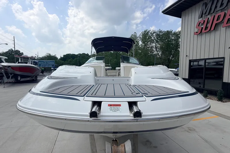 Slide: The Image of 2000 Chris Craft 262 Sport Deck boat displayed outdoors at a dealership. - 7