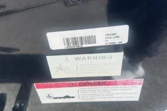 Slide: The Image of 2016 Lowe Stinger 180 warning and danger labels on boat exterior. - 10