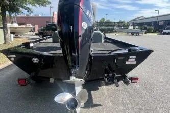 Slide: The Image of 2016 Lowe Stinger 180 boat, rear view with outboard motor, parked outdoors. - 4