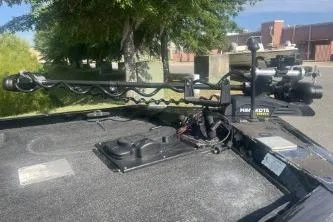 Slide: The Image of 2016 Lowe Stinger 180 boat with Minn Kota trolling motor, parked outdoors. - 8